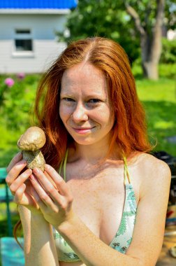 girl in a bathing suit holding a mushroom clipart