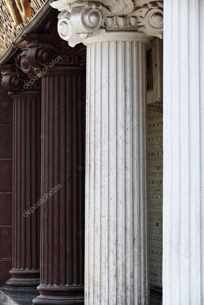 White-brown pilasters of colonnade in ionic order on the facade of a mock Venetian style house following the ground floor of a building in the area around Marco Polo's statue. Zhangye-Gansu-China.