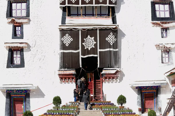 Местные жители входят в Потранг Карпо. Дворец Потала-Лхаса-Тибет. 1391 год — стоковое фото