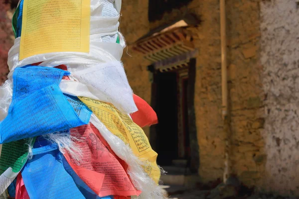 Pole post wrapped in prayer flags. Drak  Yerpa monastery-Tibet. 1519 — Stock Photo, Image