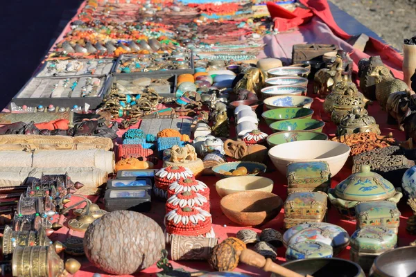 Pottery-souvenirs laid on red fabric. Smira La-Tibet. 1571 — Stock Photo, Image