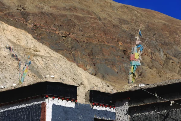 Gri duvarlar üzerinde dua bayrakları. Kasaba evleri Sakya-Tibet. 1820 — Stok fotoğraf
