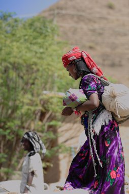 Local woman carrying items she purchased-Sunday market. Senbete-Ethiopia. 0063