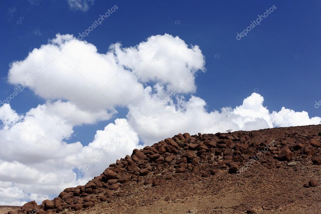 Cumulus clouds over volcanic stones-Awash river valley. Afar region-Ethiopia. 0124