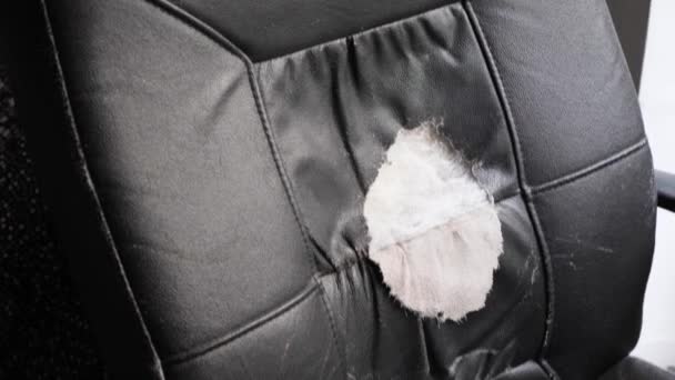 Damaged office chair with teared black leather — Stock Video