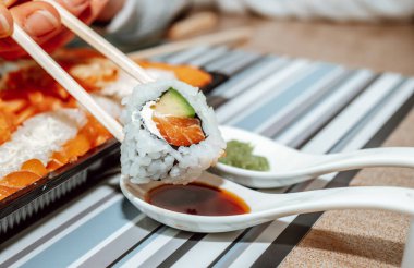 Japon mutfağı, Coronavirus 'ta yiyecek teslimatı. Ahşap bir masada siyah bir konteynırda suşi, teslimat ve sipariş.