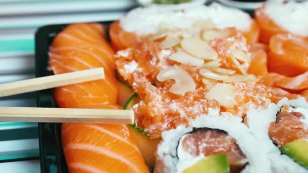 Nahsicht auf aufgeschnittene Sushi-Brötchen mit Gemüse und Lachs, gesunde, schmackhafte vegetarische Kost. Asiatische Küche. Selbstgemachtes — Stockvideo