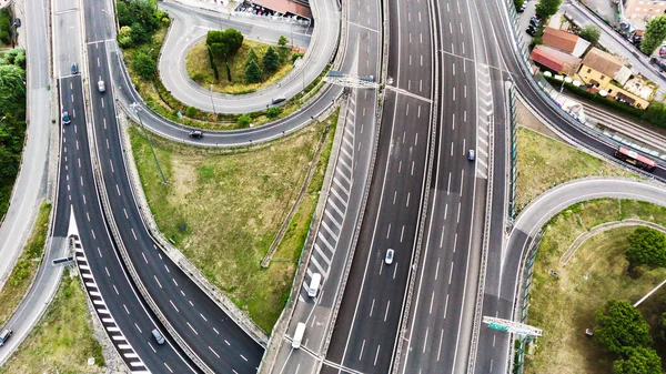 Aerial view of highway in city. Clip. Cars crossing interchange overpass. Highway interchange with traffic. Aerial bird\'s eye photo of highway. Expressway. Traffic on modern complex road intersection