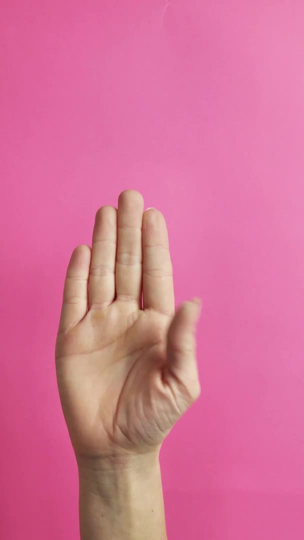 Gesture of violence of women, on a pink background — Stock Video