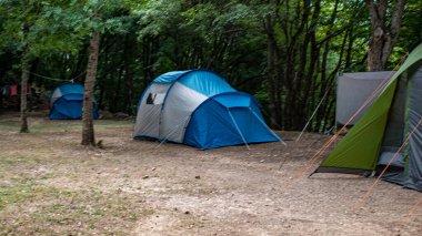Yeşil çimlerin üzerinde birkaç turist çadırı
