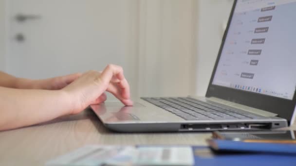 Woman chooses plane tickets using a laptop. close up — Stock Video