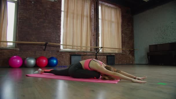 Fitness kobieta ćwiczy jogi gołębia pozę na siłowni — Wideo stockowe