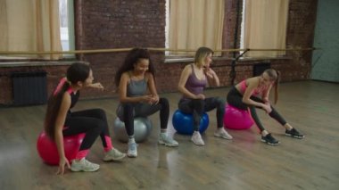 Spor salonunda spor yapan sağlıklı kadınlar spor salonunda dinleniyor.