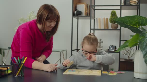 Kid with special needs playing with shape sorter toy — Stock Video