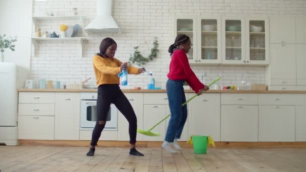 Beztroskie nastoletnie afrykańskie siostry dobrze się bawią podczas sprzątania — Wideo stockowe