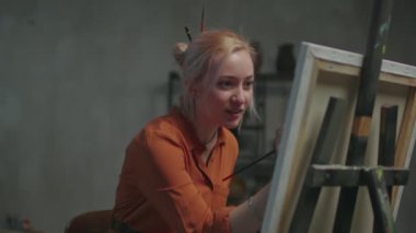 Şövaleye resim çizen pozitif kadın sanatçı.