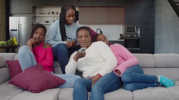 Χαρούμενη οικογένεια της Αφρικής βλέποντας τηλεόραση στον καναπέ — Αρχείο Βίντεο