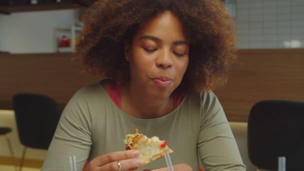 Retrato de la encantadora mujer africana disfrutando de sabrosa comida vegana en la cafetería — Vídeo de stock