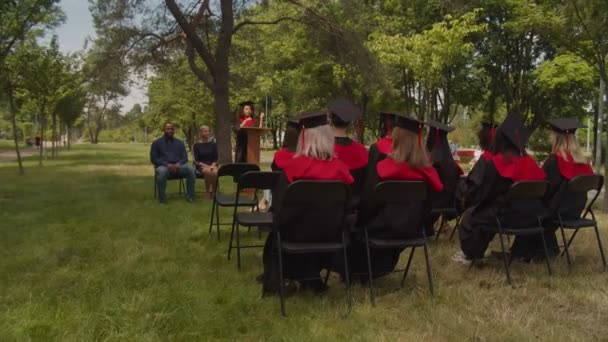 Smart african american female graduate giving speech at graduation ceremony — Stock Video