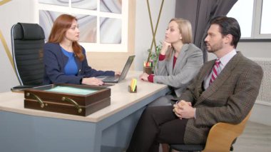 Formalite danışmanı profesyonel çekici orta yaşlı kadın finans danışmanı yatırım fırsatları hakkında çekici bir çift, iş yerindeki anlaşmanın finansal faydalarını açıklıyor..