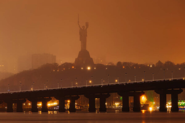 Paton Bridge at Night in Autumn, Kyiv, Ukraine. Night view of the historic Paton Bridge illuminated over the Dnipro River in Kyiv, Ukraine, during the autumn season.