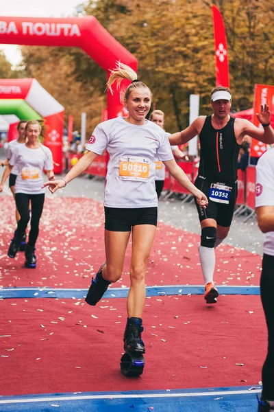 POLTAVA, UKRAINE - 1 EYLÜL 2019: Atlama tesislerinde çalışan sportif bir kadın Nova Poshta Poltava Yarı Maratonu sırasında bitiş çizgisine ulaştı