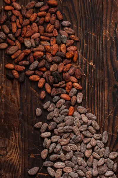 Raw cocoa beans two types Venezuela on brown background.