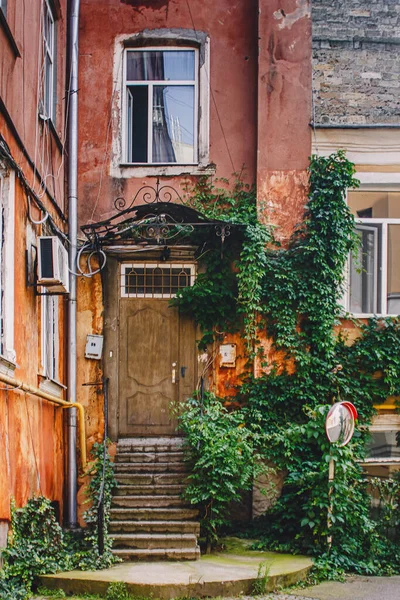 Old wooden weathered door in ancient town architecture.