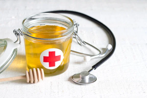 Honey is a cure abstract health lifestyle concept with aid kit and stethoscope — Stock Photo, Image