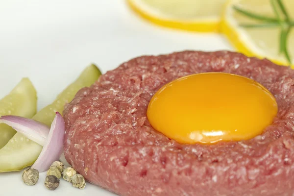 Beef raw tartare with yolk onion and cucumber — Stock Photo, Image