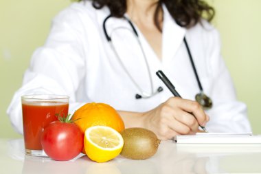 Doctor nutritionist in office with healthy fruits diet concept clipart