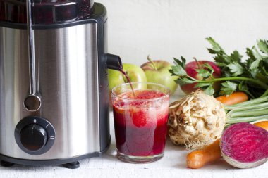 Juicer and juice with fresh fruits and vegetables clipart