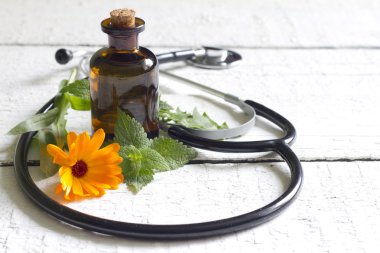 Alternative medicine herbs and stethoscope concept clipart