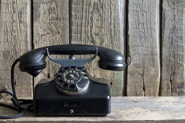 Old retro telephone on vintage boards Stock Picture