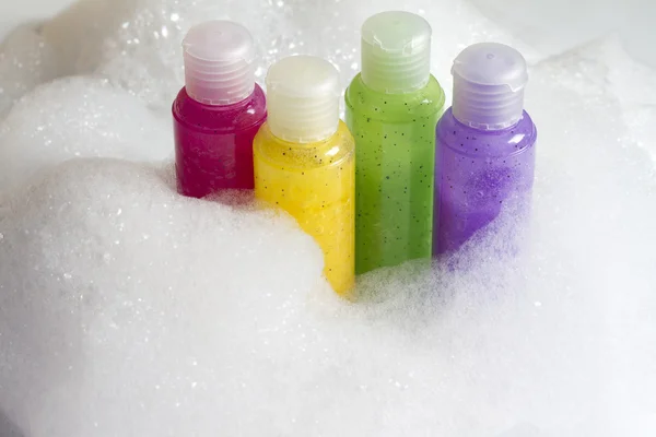 Colorful soaps cosmetics in the bathroom in foam abstract — Stock Photo, Image