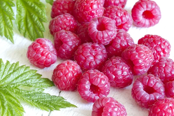 Raspberry with green leaves on white background closeup — Stock Photo, Image