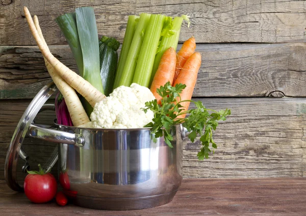 Fresh vegetables in the pot on vintage boards cooking concept — Stock Photo, Image