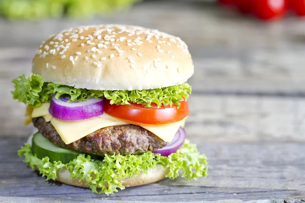 Hamburger on vintage wooden board closeup — Stock Photo, Image