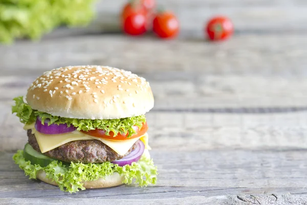 Hamburger on vintage wooden board closeup — Stock Photo, Image