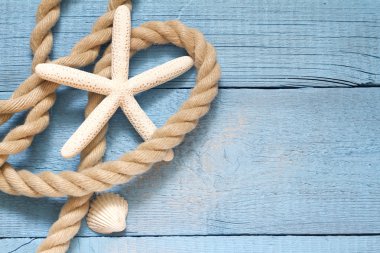 Starfish and fishing net on blue boards abstract vacation concept
