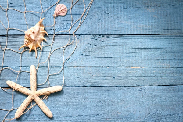 Starfish and fishing net on blue boards abstract vacation concept — Stockfoto