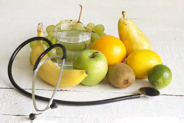 Estetoscopio y concepto de dieta de frutas frescas —  Fotos de Stock