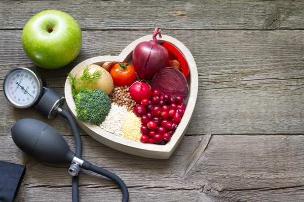 Healthy food in heart and cholesterol diet concept on vintage boards — Stock Photo, Image