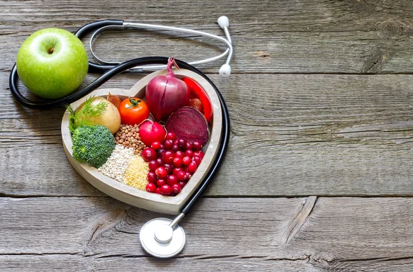 Healthy food in heart and cholesterol diet concept on vintage boards — Stock Photo, Image