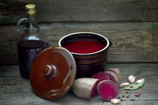 Pickled beetroots and homemade juice on vintage boards in kitchen — Stock Photo, Image
