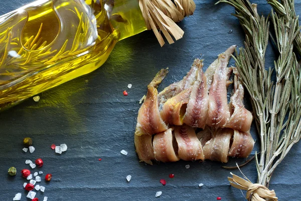 Anchoas con sal, aceite y especias sobre mármol negro — Foto de Stock