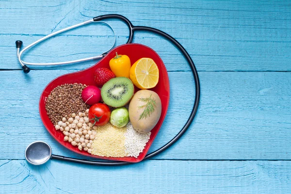 Food on heart plate with stethoscope cardiology concept — Stock Photo, Image