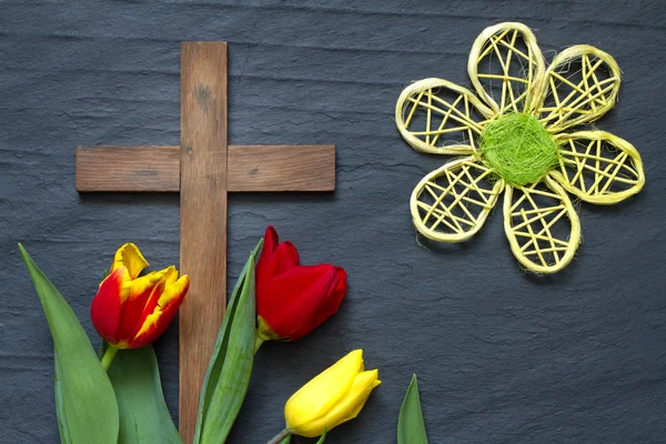 Abstract easter tulips and wooden cross on black marble — Stock Photo, Image
