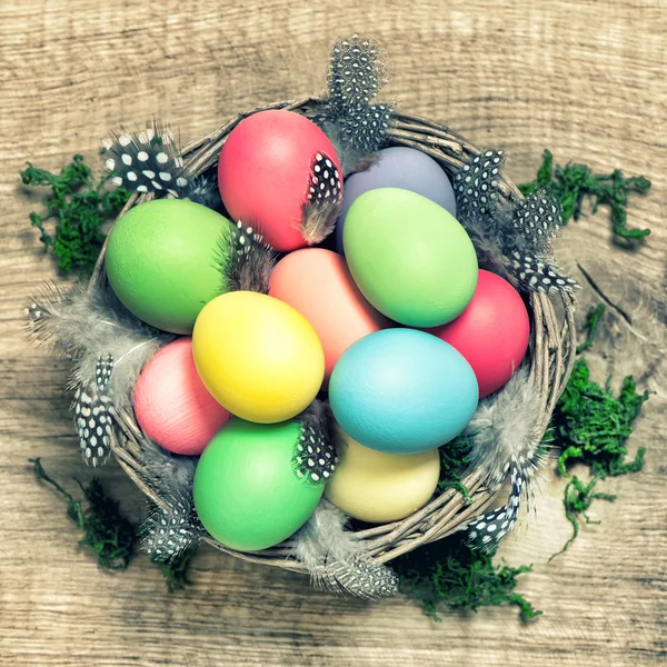 Easter eggs with feather decoration vintage toned — Stock Photo, Image