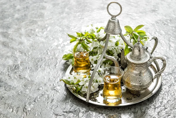 Tea glasses pot. Silver dishes decoration flowers — Stock Photo, Image